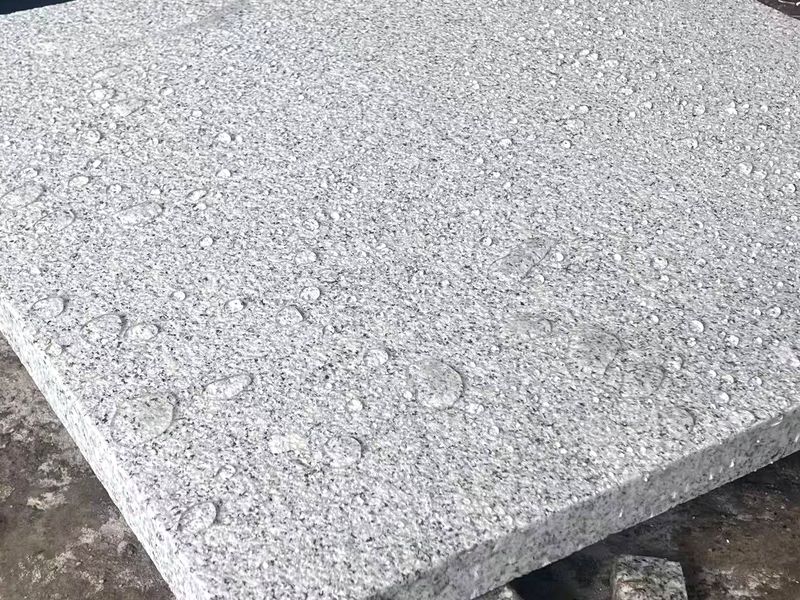 G603 Sesame Grey granite slab, flamed finish, water beading on the surface at the Lianjiang plant